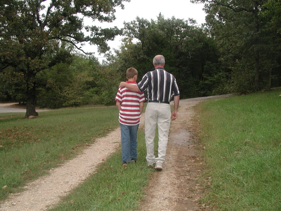 Ken Ortman and a boy walking down a path